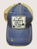 Blue denim cap with yellow mesh back and text patch on a light gray background