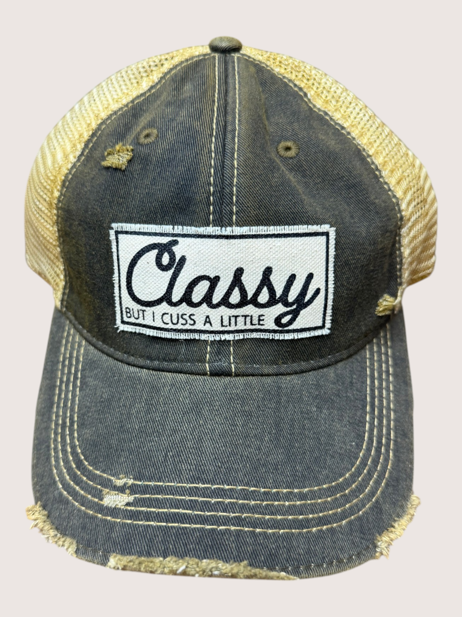 Denim cap with mesh back and 'Classy But I Cuss A Little' patch on a light gray background