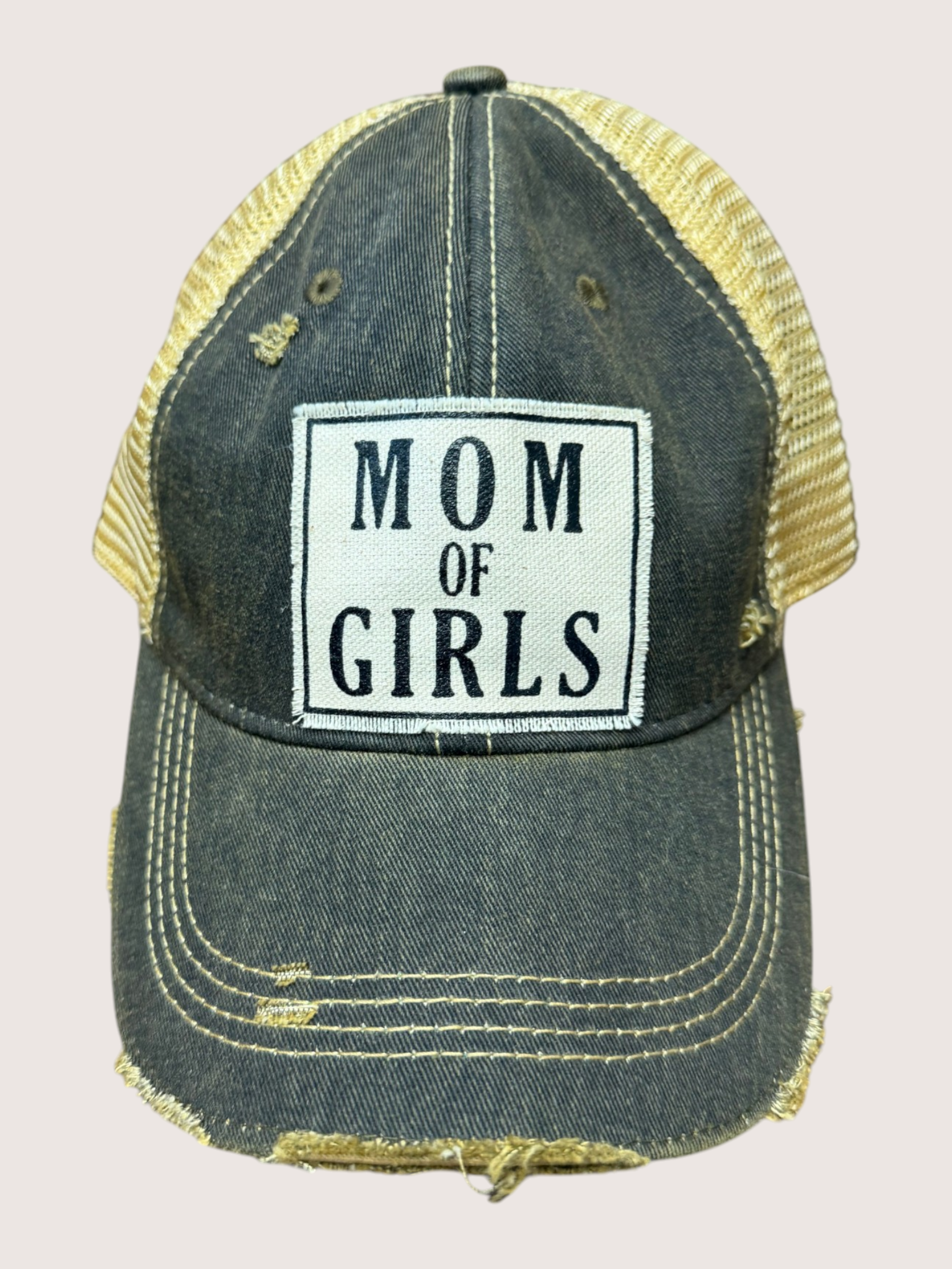 Denim cap with 'Mom of Girls' patch on a light gray background