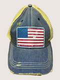 Blue denim cap with American flag patch on a beige background