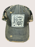 Vintage-style cap with a patch reading 'Sassy, Classy & a bit Smart Assy' on a light gray background