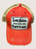 Red cap with gold brim and 'Sunshine mixed with a little Hurricane' text on a light gray background