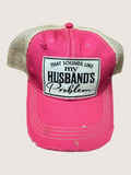 Pink cap with a humorous patch on a light beige background