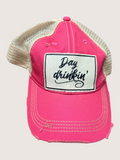 Pink cap with 'Day drinkin'' patch on a light gray background