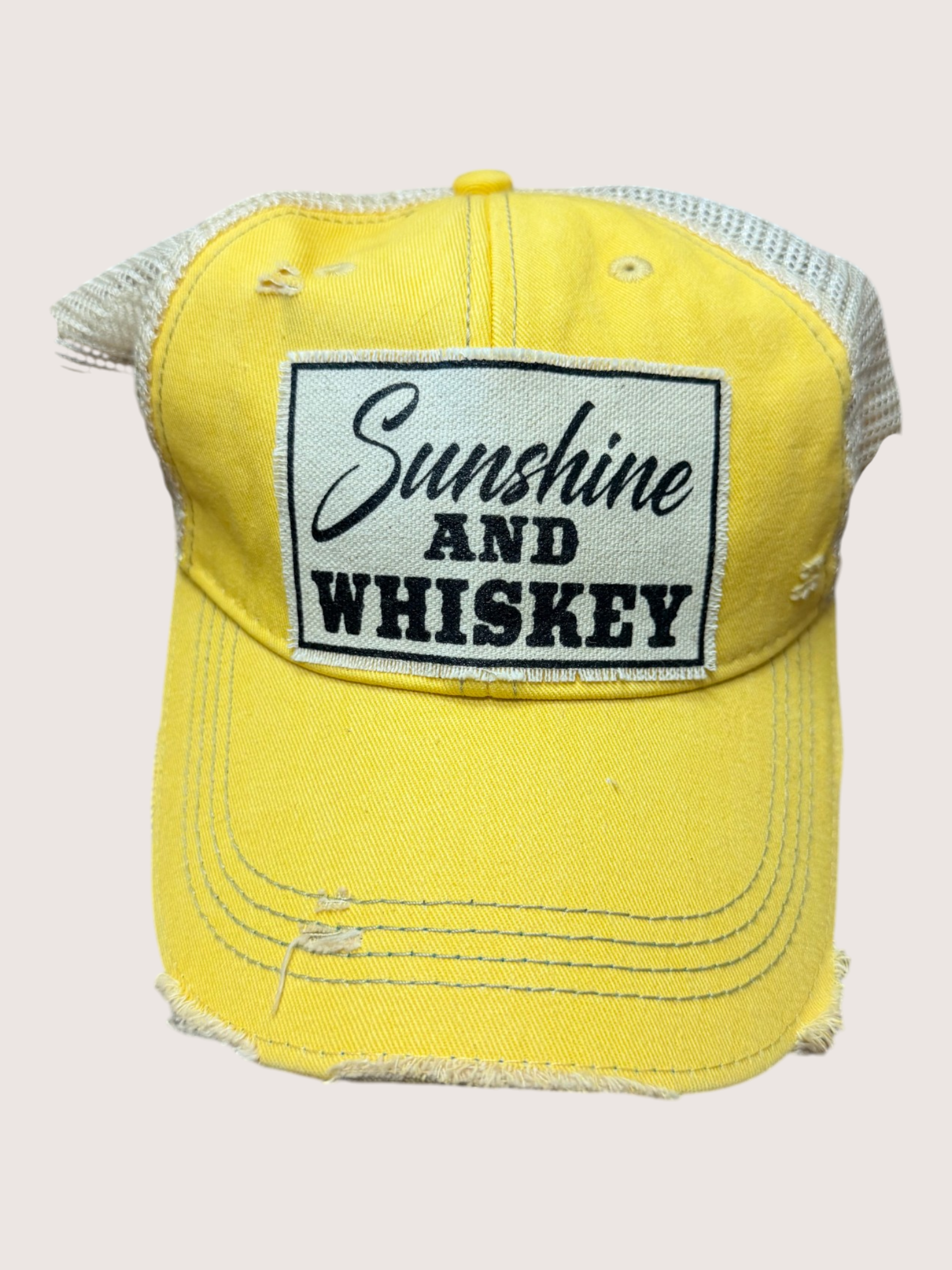 Yellow cap with 'Sunshine and Whiskey' text on a white background