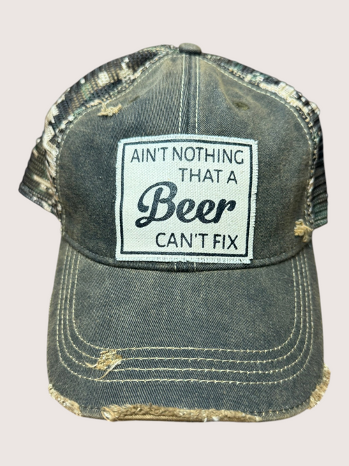 Vintage-style cap with a patch reading 'Ain't nothing that a beer can't fix' on a light gray background