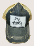 Denim cap with 'Day drinkin'' patch on a beige background