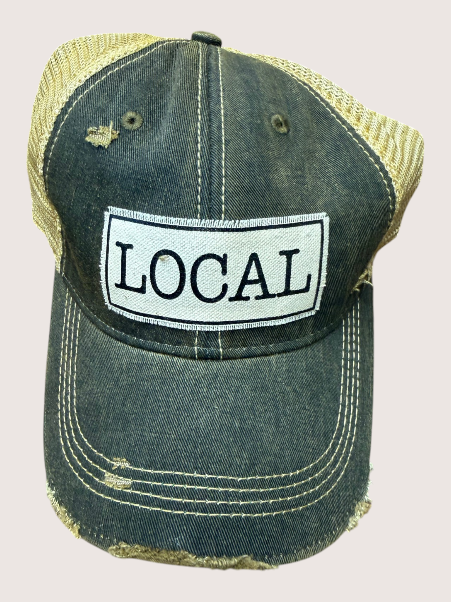 Denim cap with 'LOCAL' patch on a light gray background