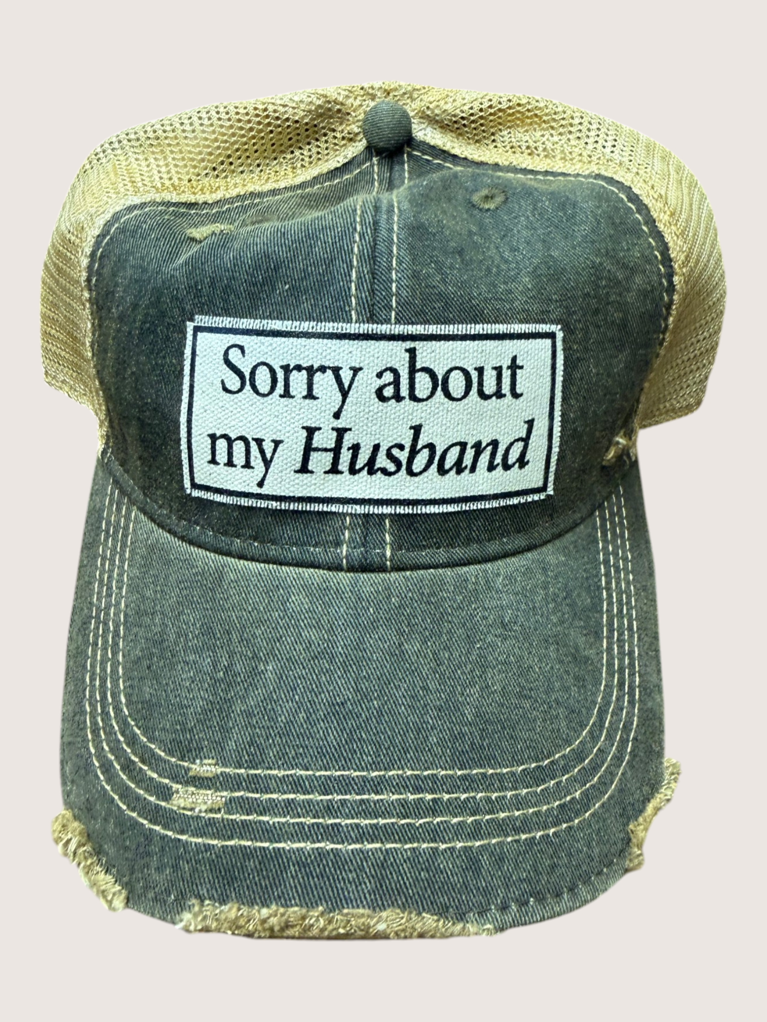 Vintage-style cap with 'Sorry about my Husband' text on a light gray background