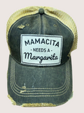 Black distressed trucker cap with 'Mamacita Needs a Margarita' text on a light gray background