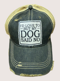Black distressed cap with 'I'd love to, but my dog said no' text on a beige background