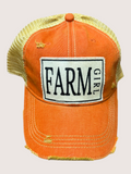 Orange cap with 'Farm Girl' patch on a light gray background