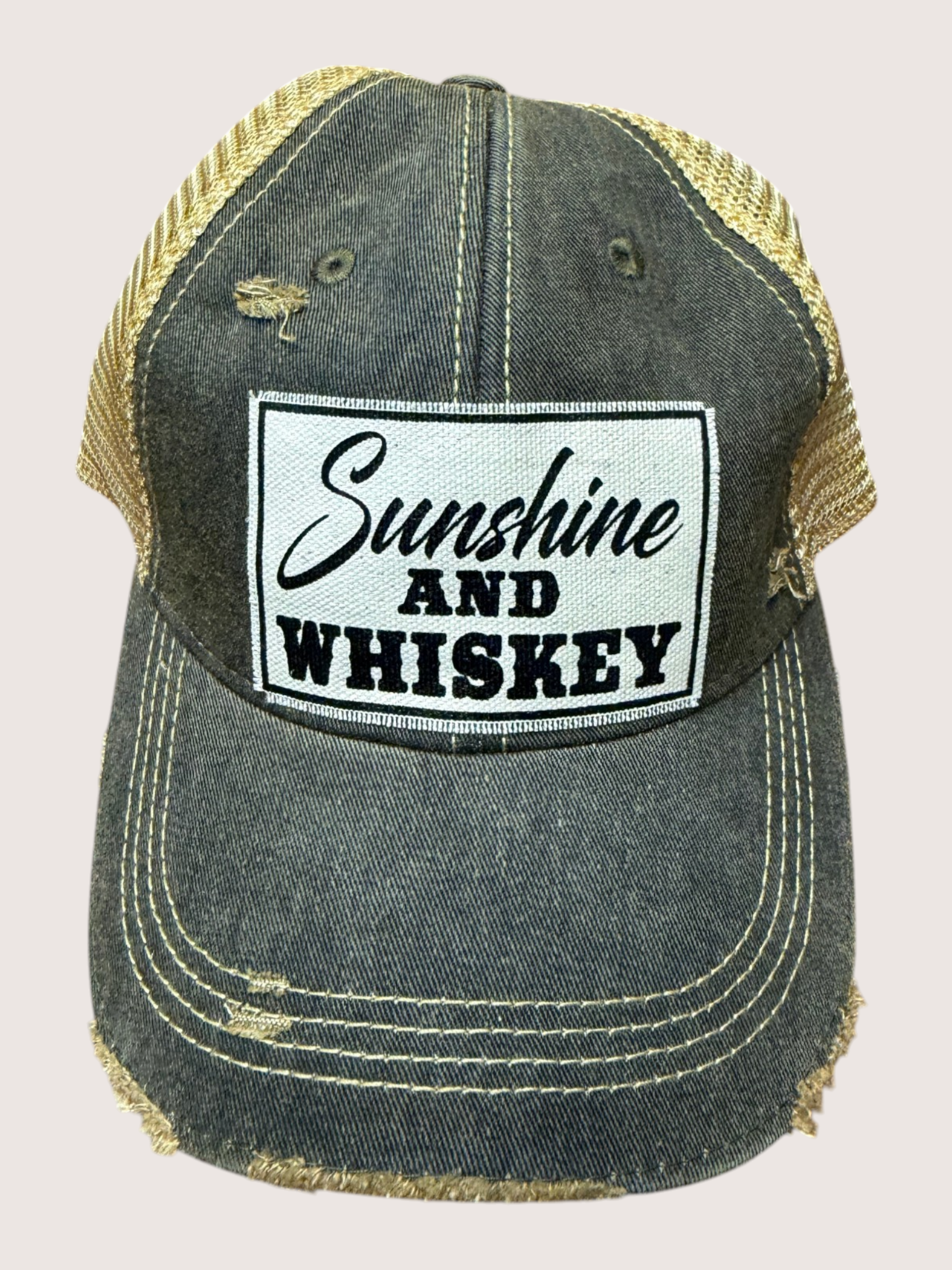 Denim cap with 'Sunshine and Whiskey' patch on a light gray background