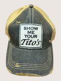 Vintage-style cap with 'Show Me Your Tito's' patch on a light gray background
