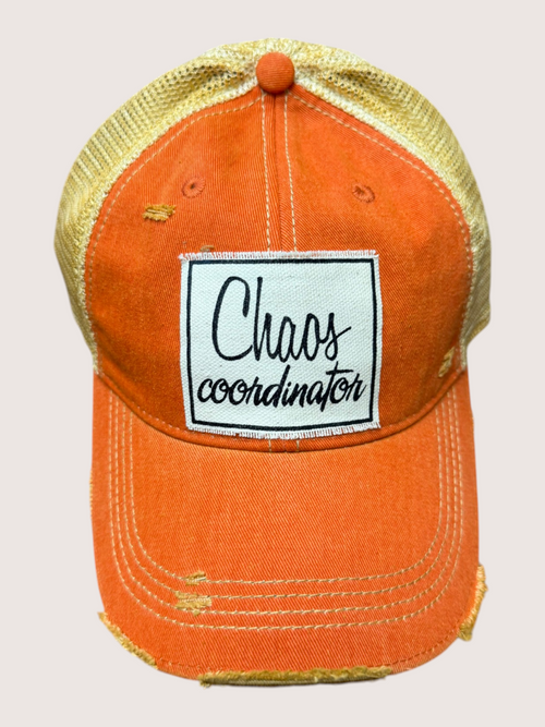 Orange cap with 'Chaos coordinator' patch on a light gray background