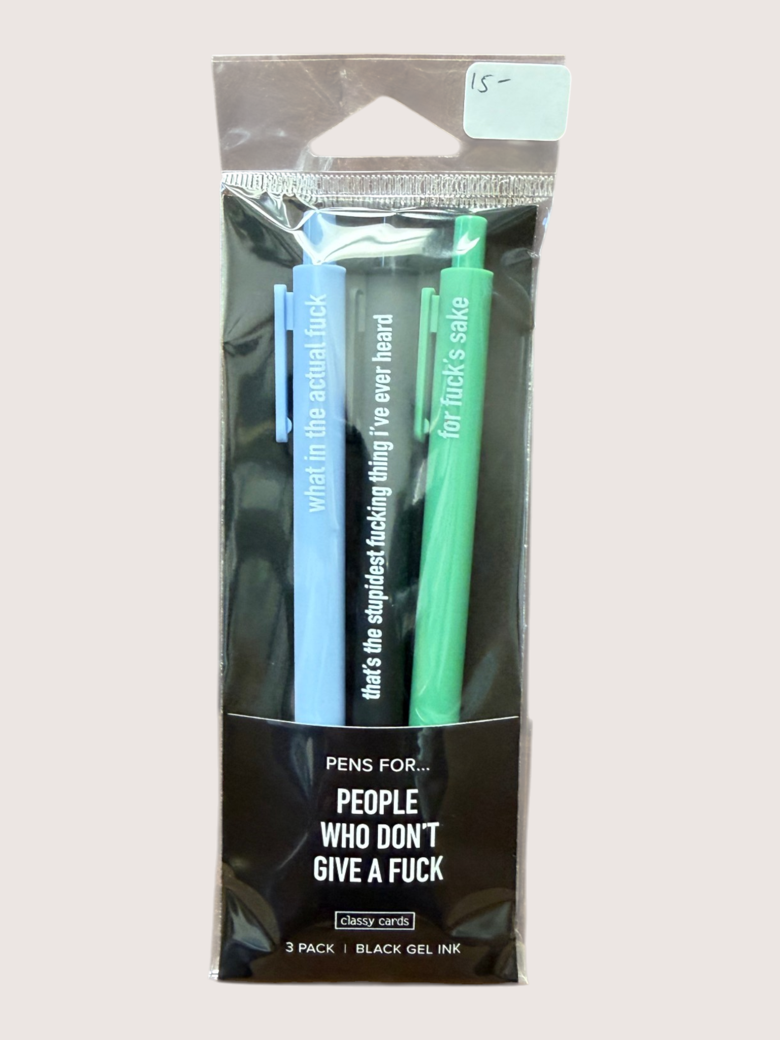 Packaged pens with humorous text in a clear plastic sleeve on a light gray background