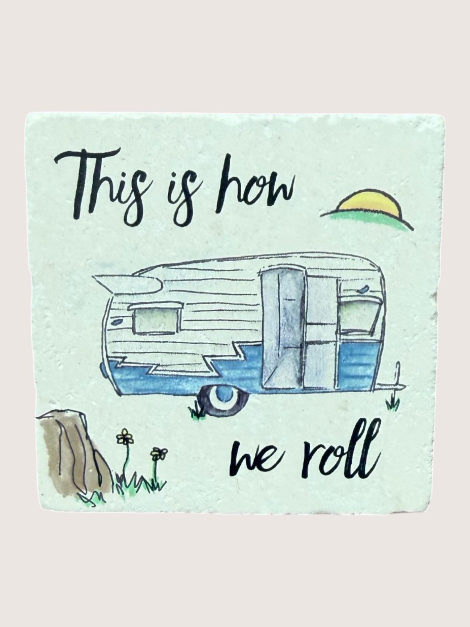 coaster with Illustration of a camper with text 'This is how we roll' on a light blue background
