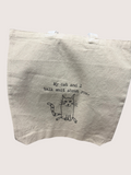 Beige tote bag with a cat illustration and text on a white background