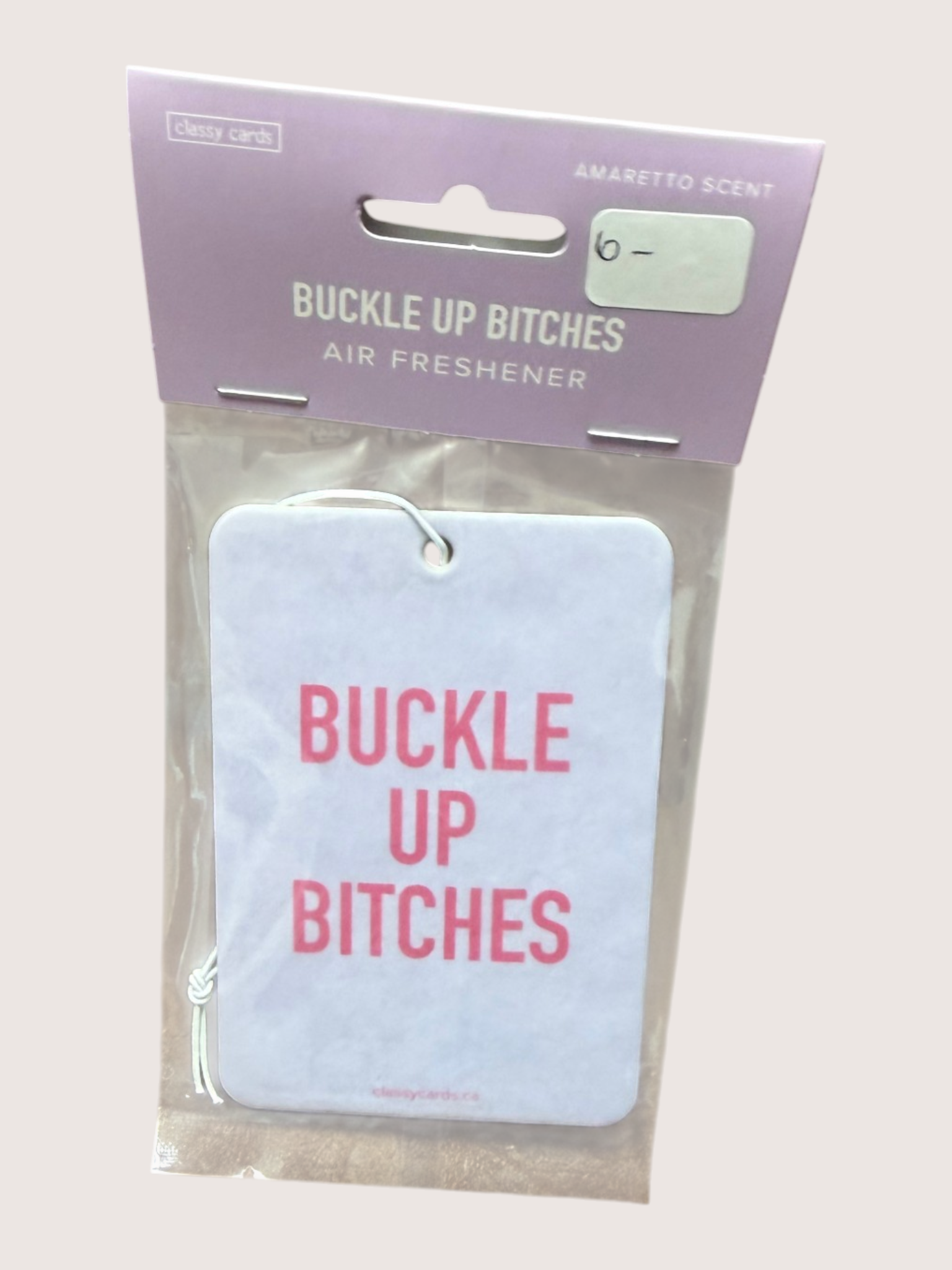 Air freshener with 'Buckle Up Bitches' text in clear packaging on a light background