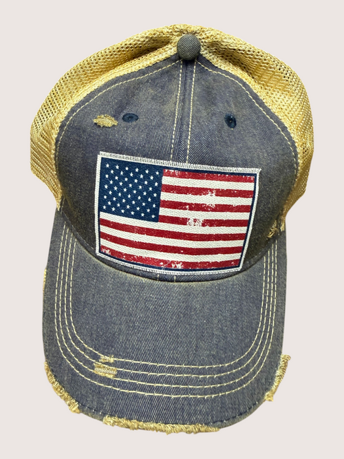 Denim cap with American flag patch on a light gray background