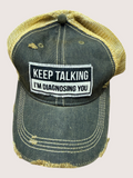 Vintage-style cap with a patch reading 'Keep Talking I'm Diagnosing You' on a light pink background