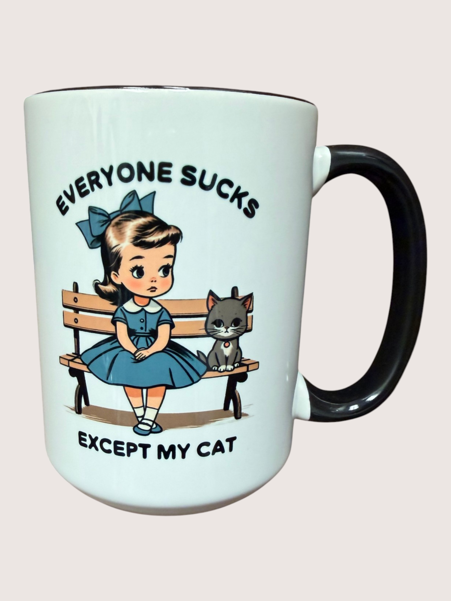 Mug with a cartoon girl and cat on a bench and text 'Everyone sucks except my cat' on a light blue background.