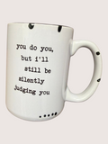 White mug with black text on a light gray background