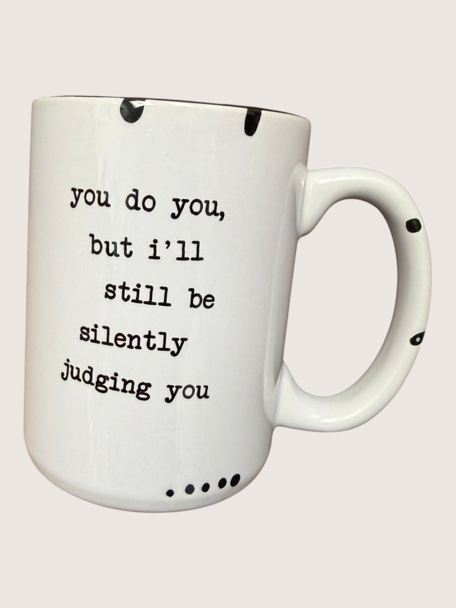 White mug with black text on a light gray background