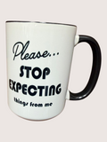 White mug with black text 'Please... Stop Expecting things from me' on a white background