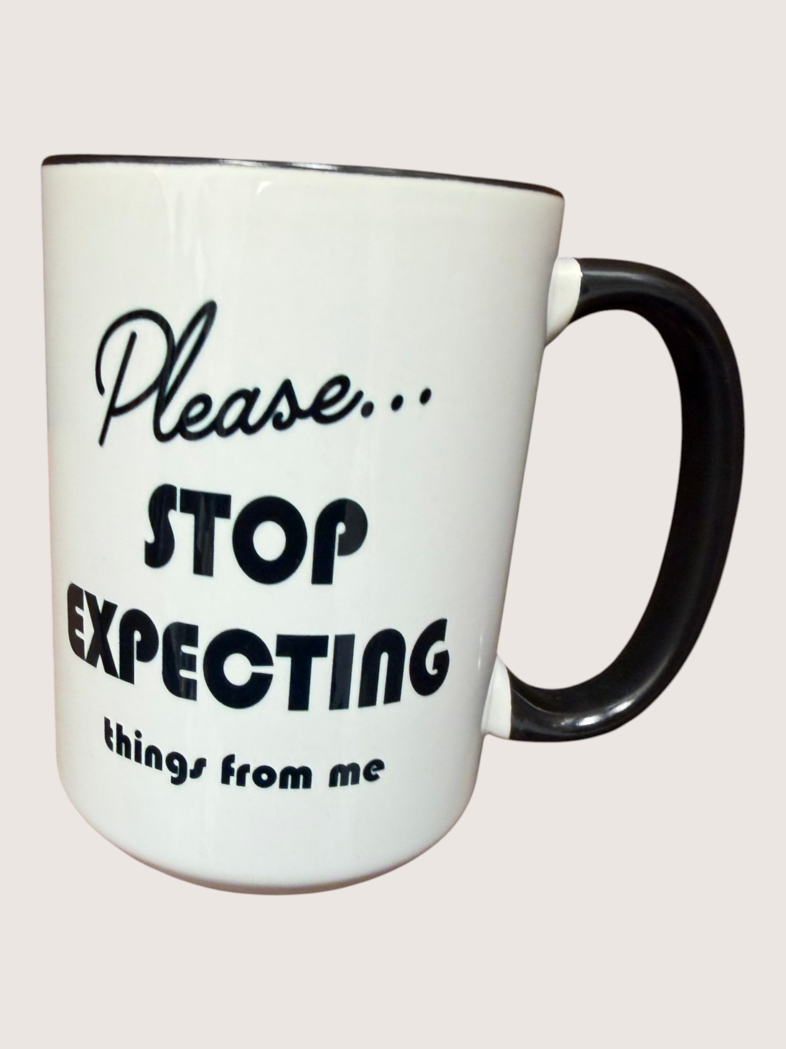 White mug with black text 'Please... Stop Expecting things from me' on a white background