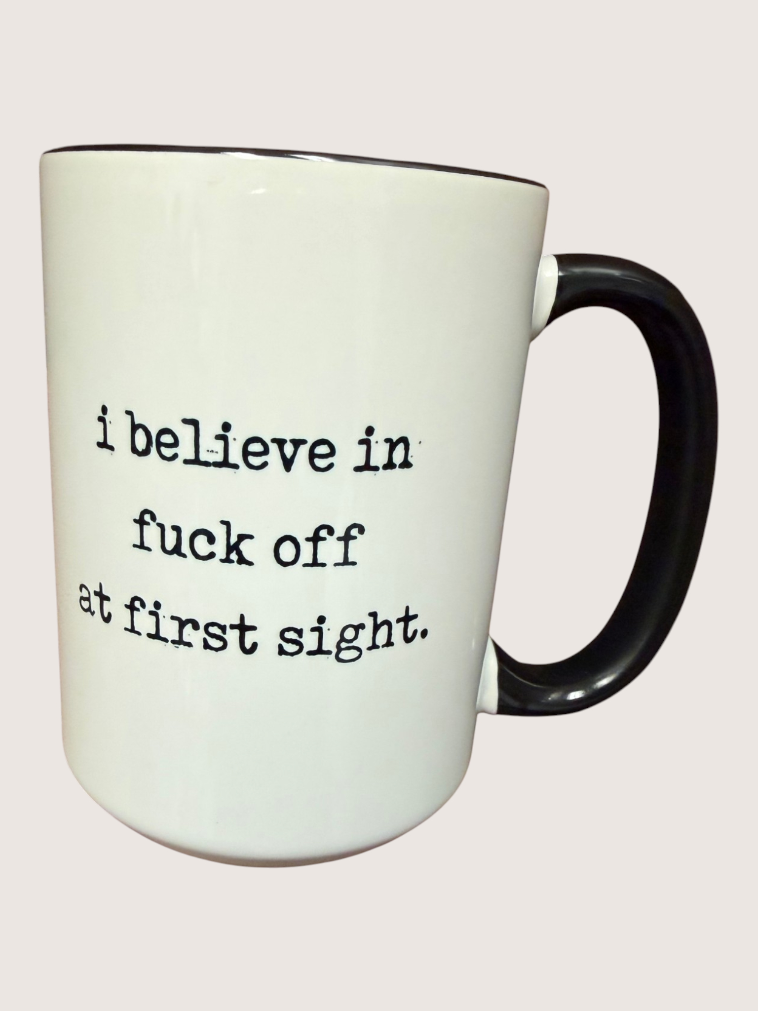 White mug with black text on a white background
