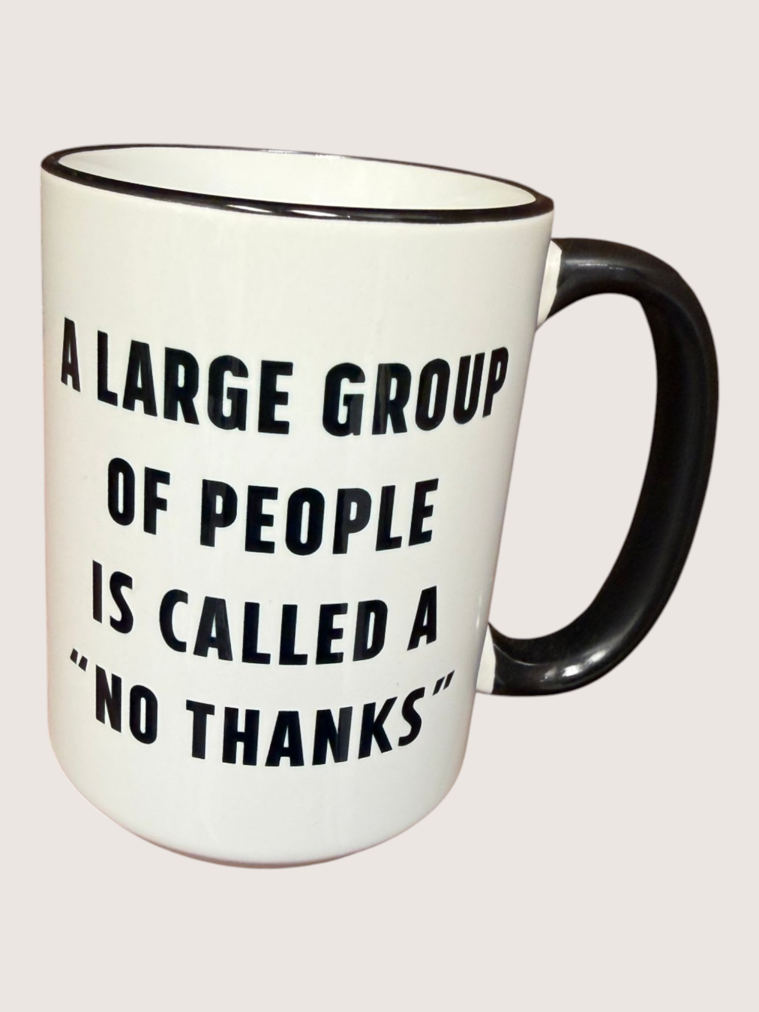 White mug with black text and handle on a light gray background