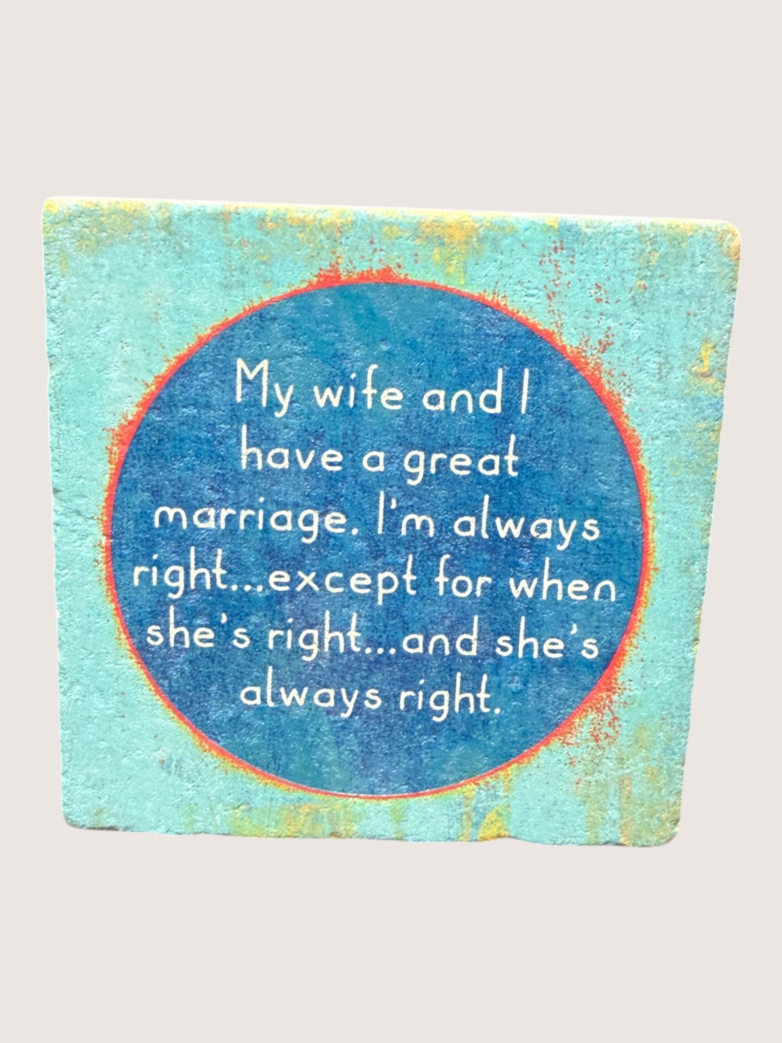 Textual coaster with humorous quote on a blue circular background