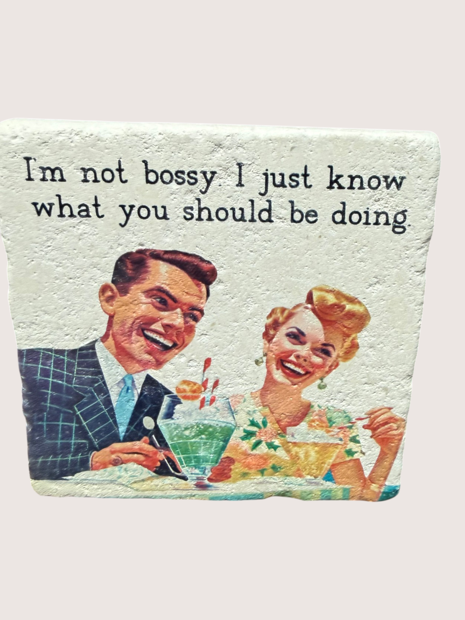 Vintage-style coaster illustration of a man and woman with text 'I'm not bossy I just know what you should be doing' on a light green background.