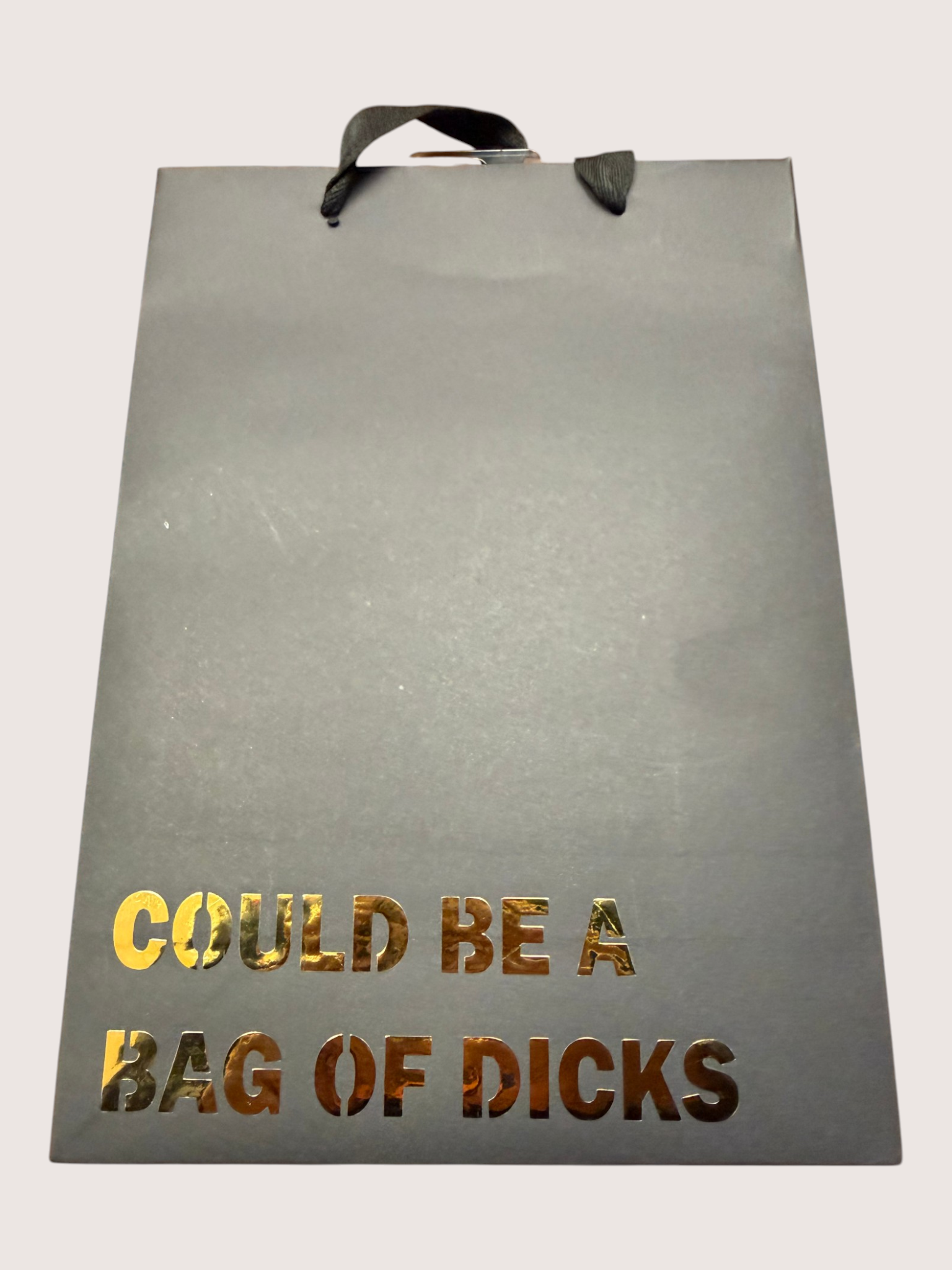 black gift bag with gold text on a white background