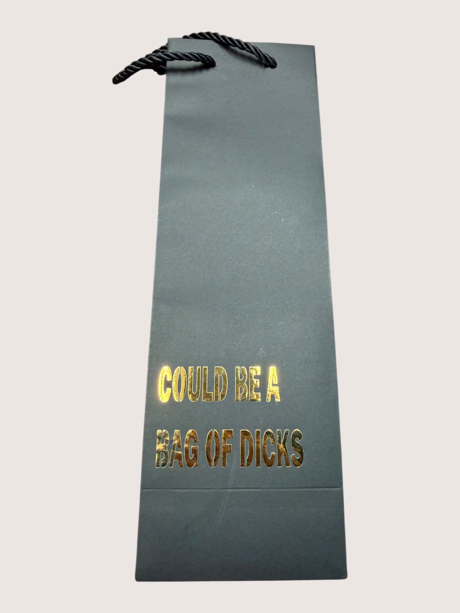 black gift bag with gold text on a light gray background