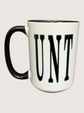 White mug with black handle and 'UNT' text on a light gray background
