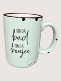 Mint green mug with black text on a light pink background