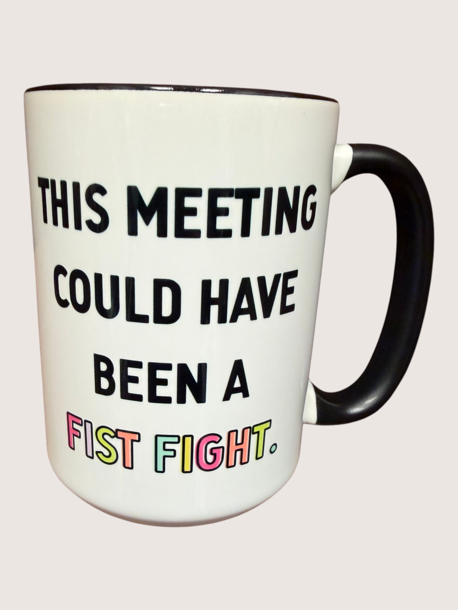 Mug with text 'This meeting could have been a fist fight.' on a white background