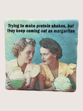Vintage-style coaster with two women holding protein shakes and a humorous text overlay.
