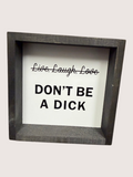 Framed sign with text 'Live. Laugh. Love. DON'T BE A DICK' on a white background