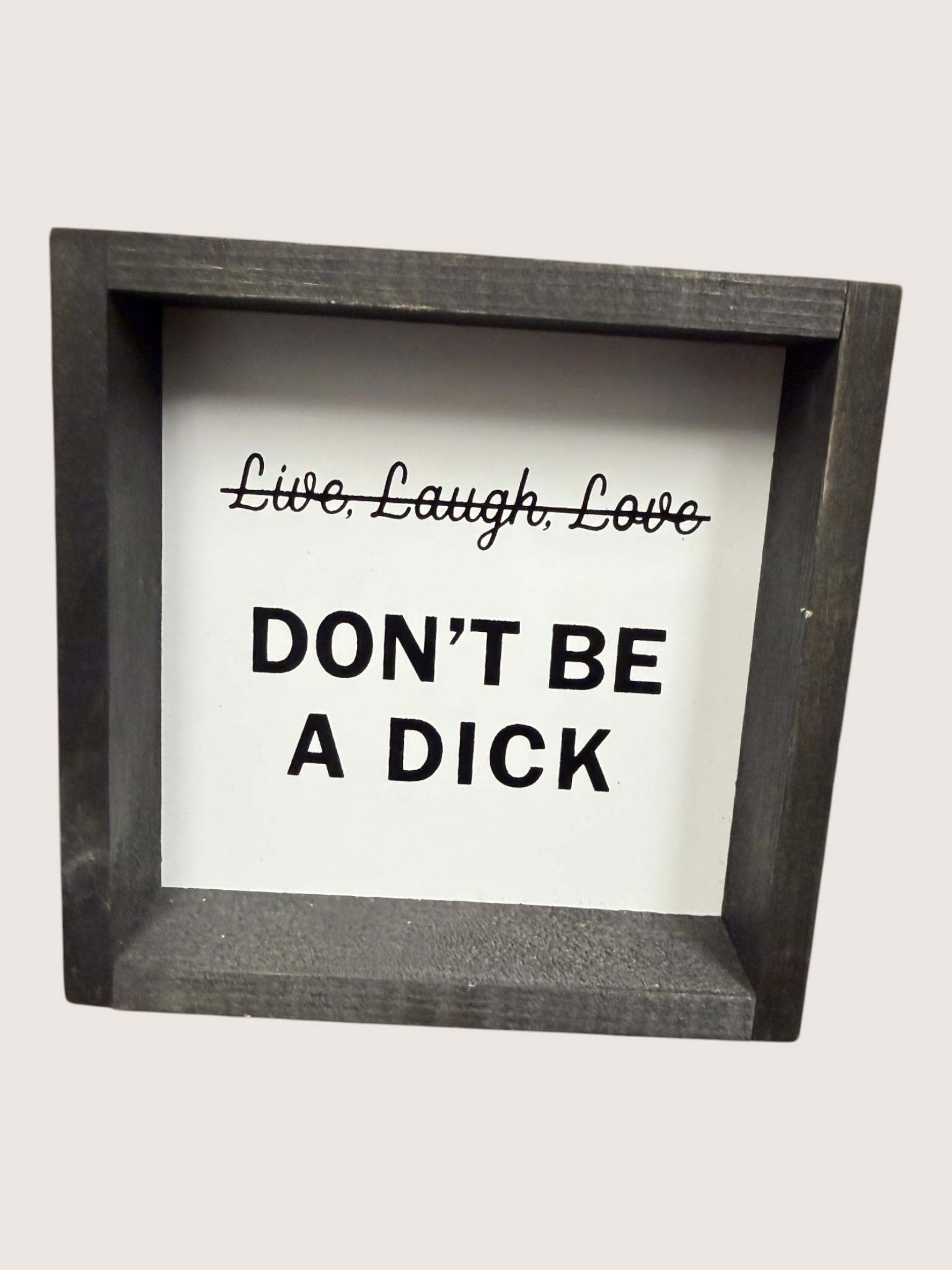 Framed sign with text 'Live. Laugh. Love. DON'T BE A DICK' on a white background