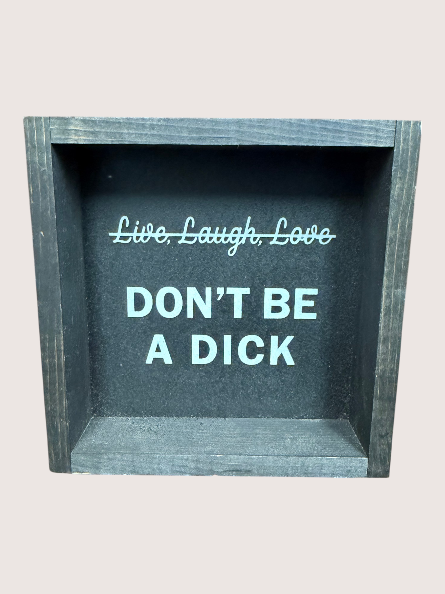 Decorative box with text 'Live, Laugh, Love DON'T BE A DICK' on a light gray background