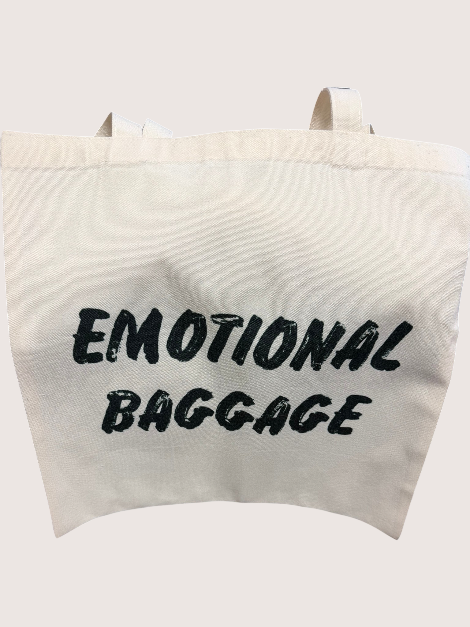 Tote bag with 'EMOTIONAL BAGGAGE' text on a white background