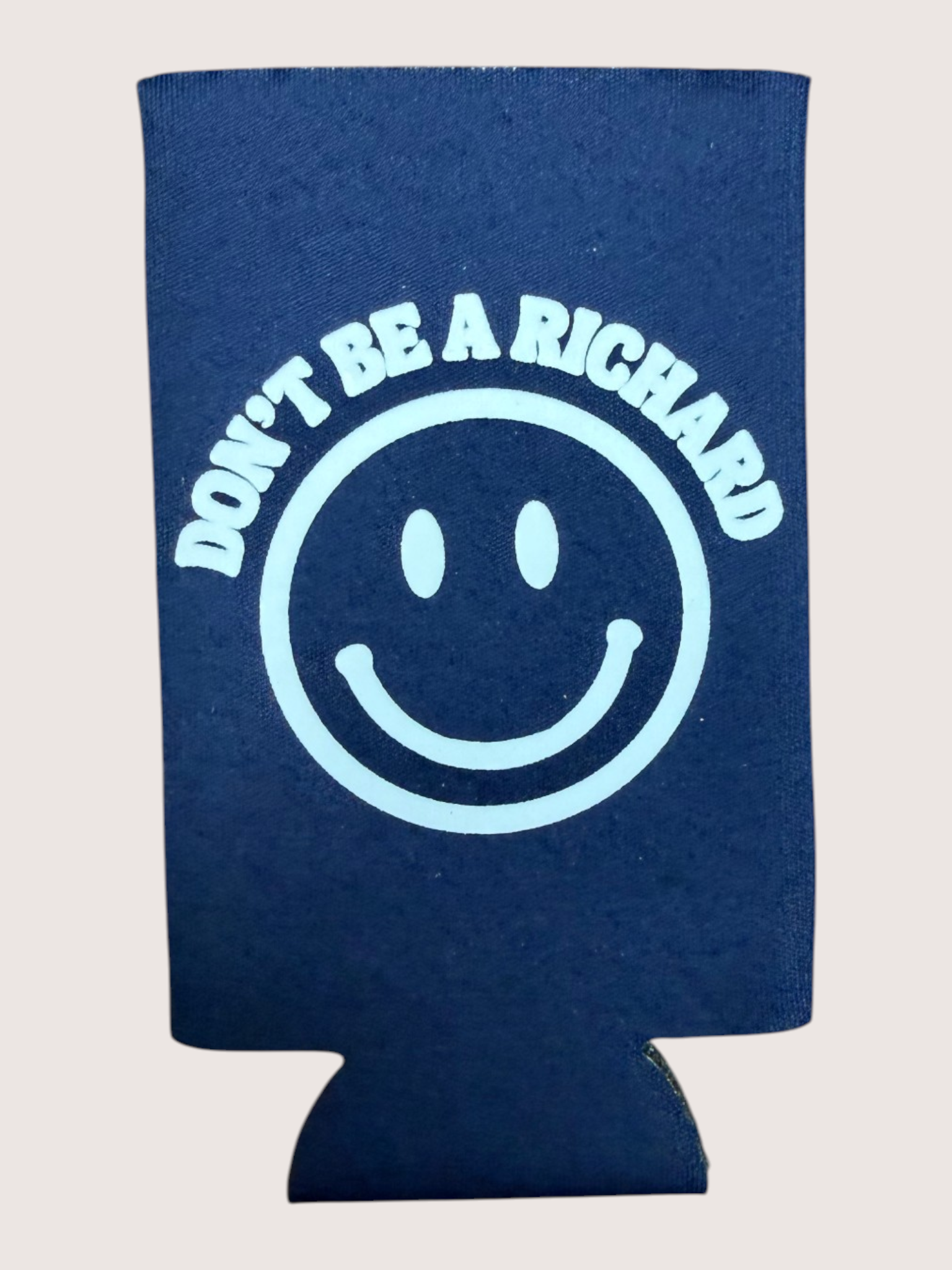 Navy blue can cooler with smiley face and text 'Don't be a Richard' on a light gray background