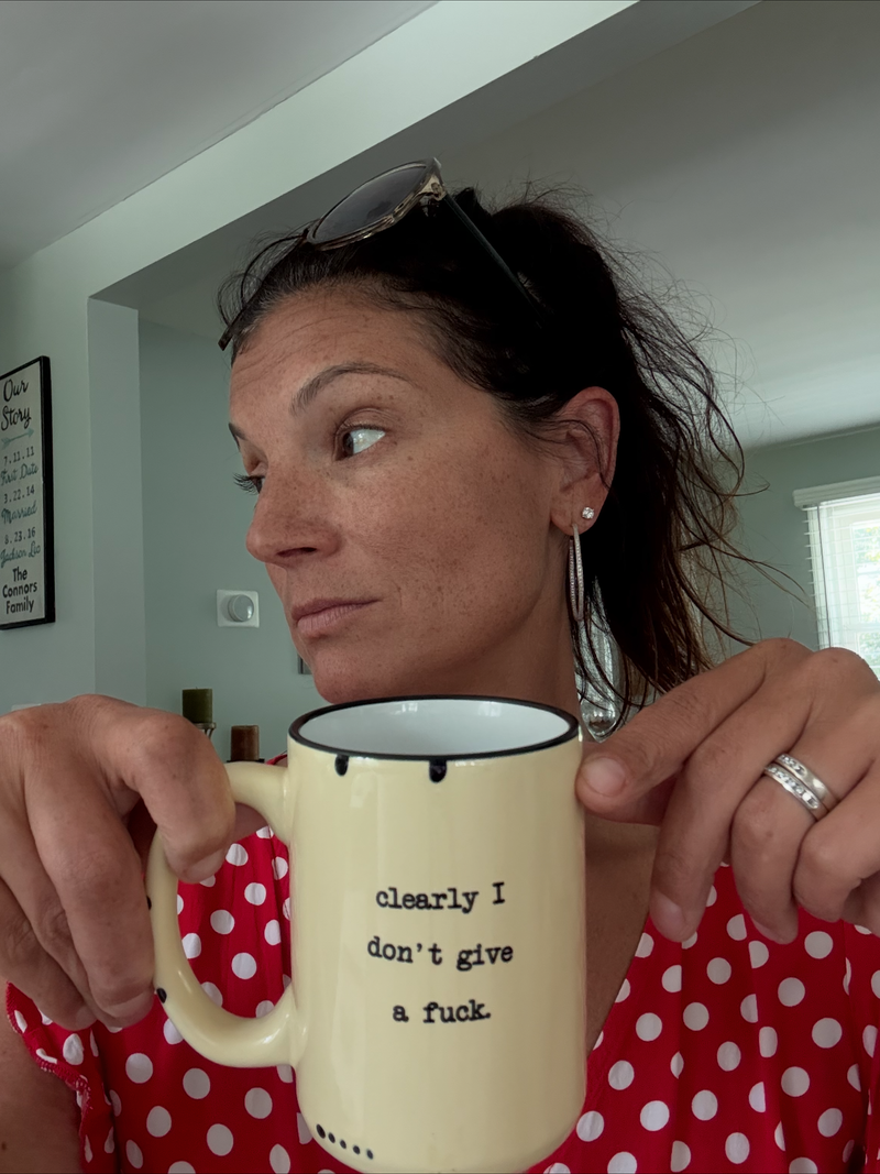 Jill holding a funny Hustle and Heart mug